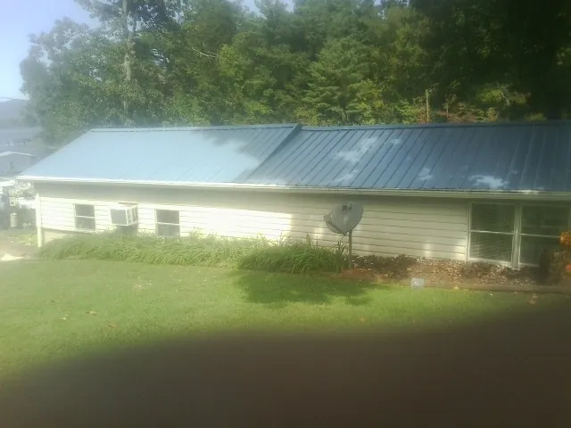 Blue metal roof running the length of a single story home in Hadley